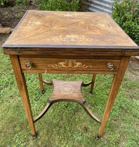 Antique small wooden desk that is dull and requires restoration and repolishing.