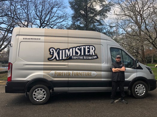 Tony Kilmister standing in front of the Kilmister Furniture Restoration van.