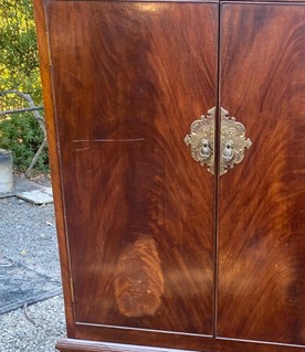 Wooden cabinet showing a large scratch on the surface.
