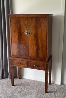 Wooden cabinet that has had a large scratch repaired.