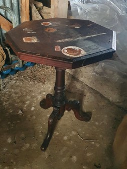 Wooden coffee table that has smoke damage from a fire.