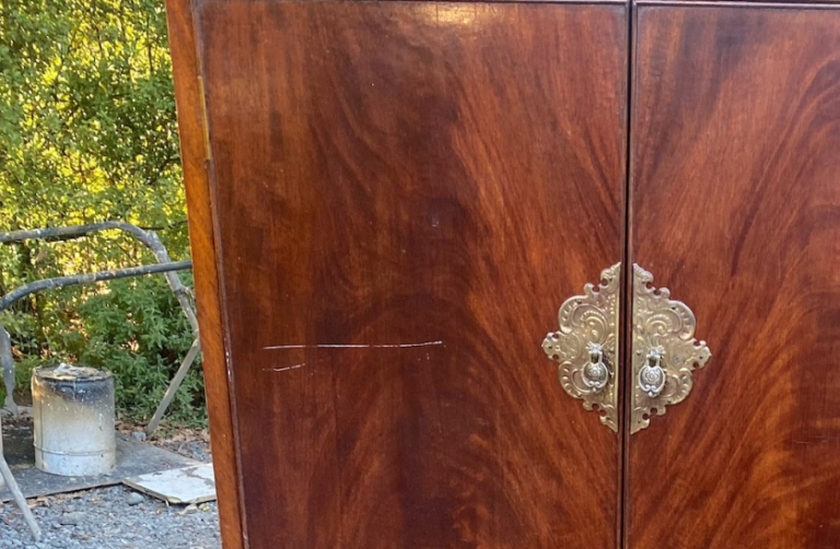 Wooden cabinet showing a large scratch on the surface.