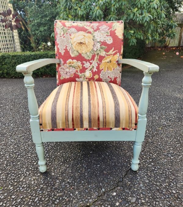 Dull looking chair that needs to be repolished and reupholstered.