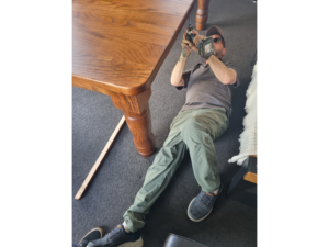 Tony Kilmister of Kilmister Furniture Restoration screwing a table together